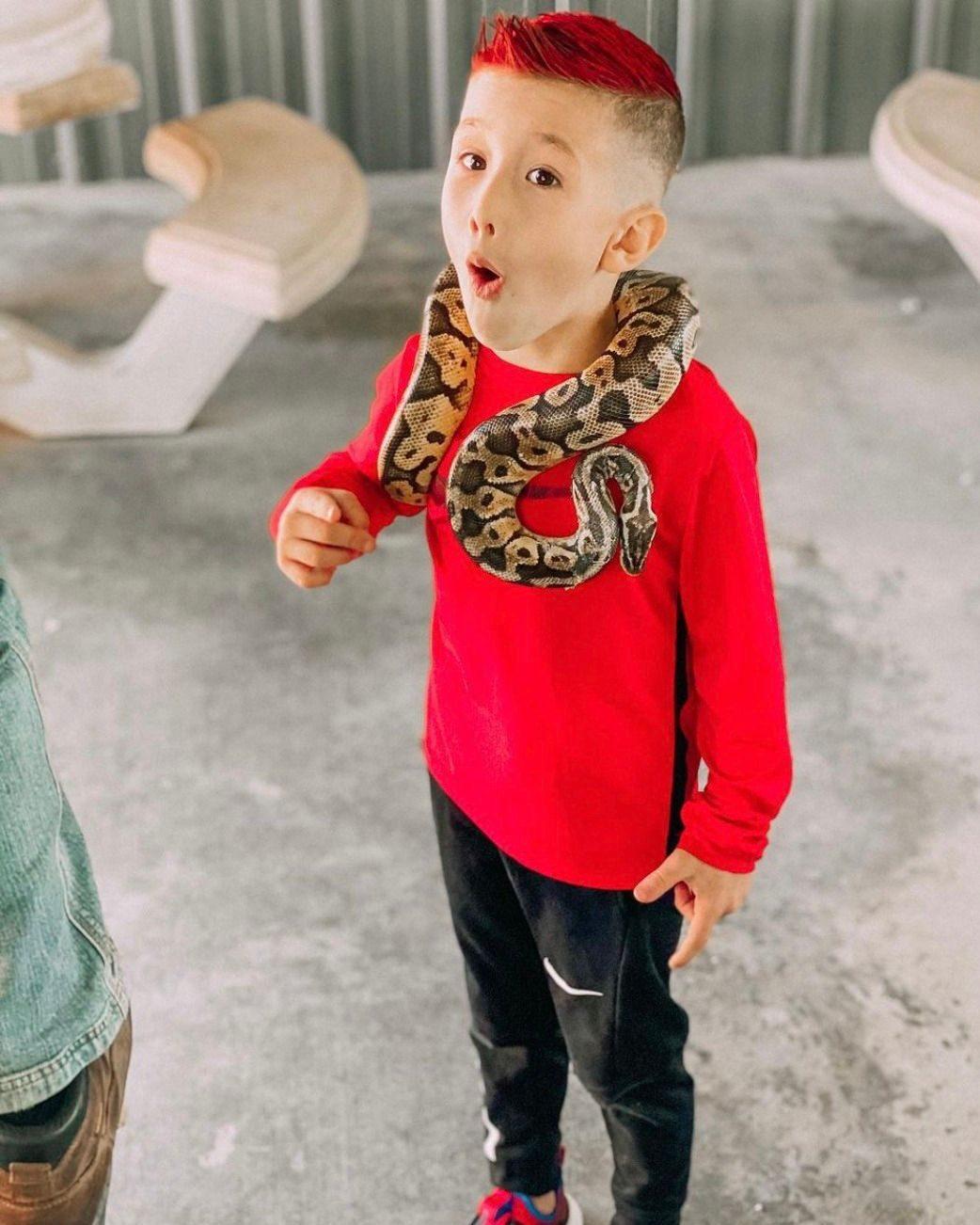 Boy saying wow with snake around shoulders