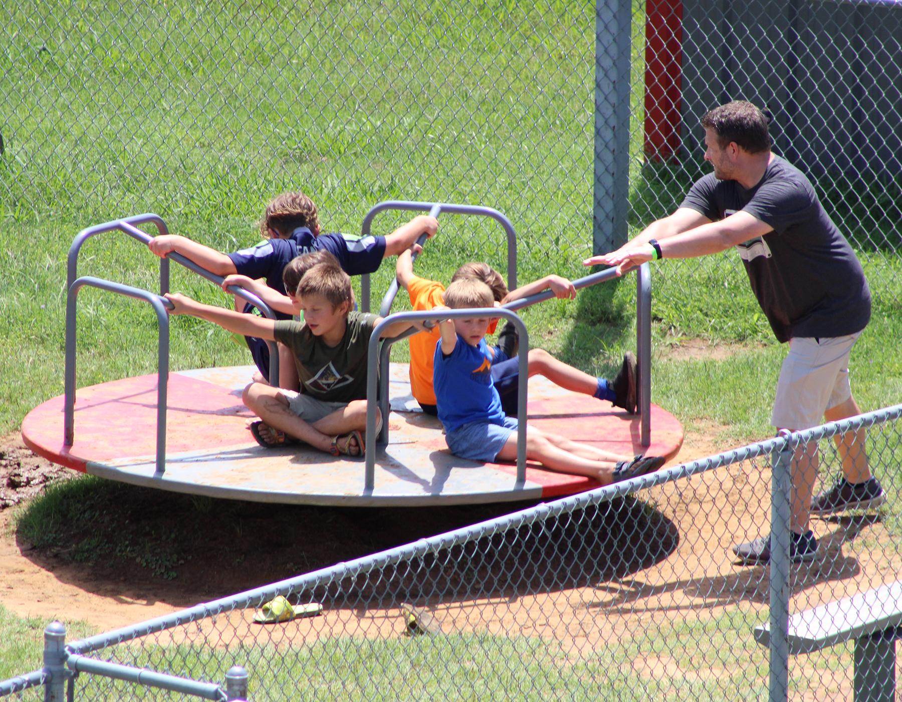 Kids on merry go round at Sharkarosa Zoo