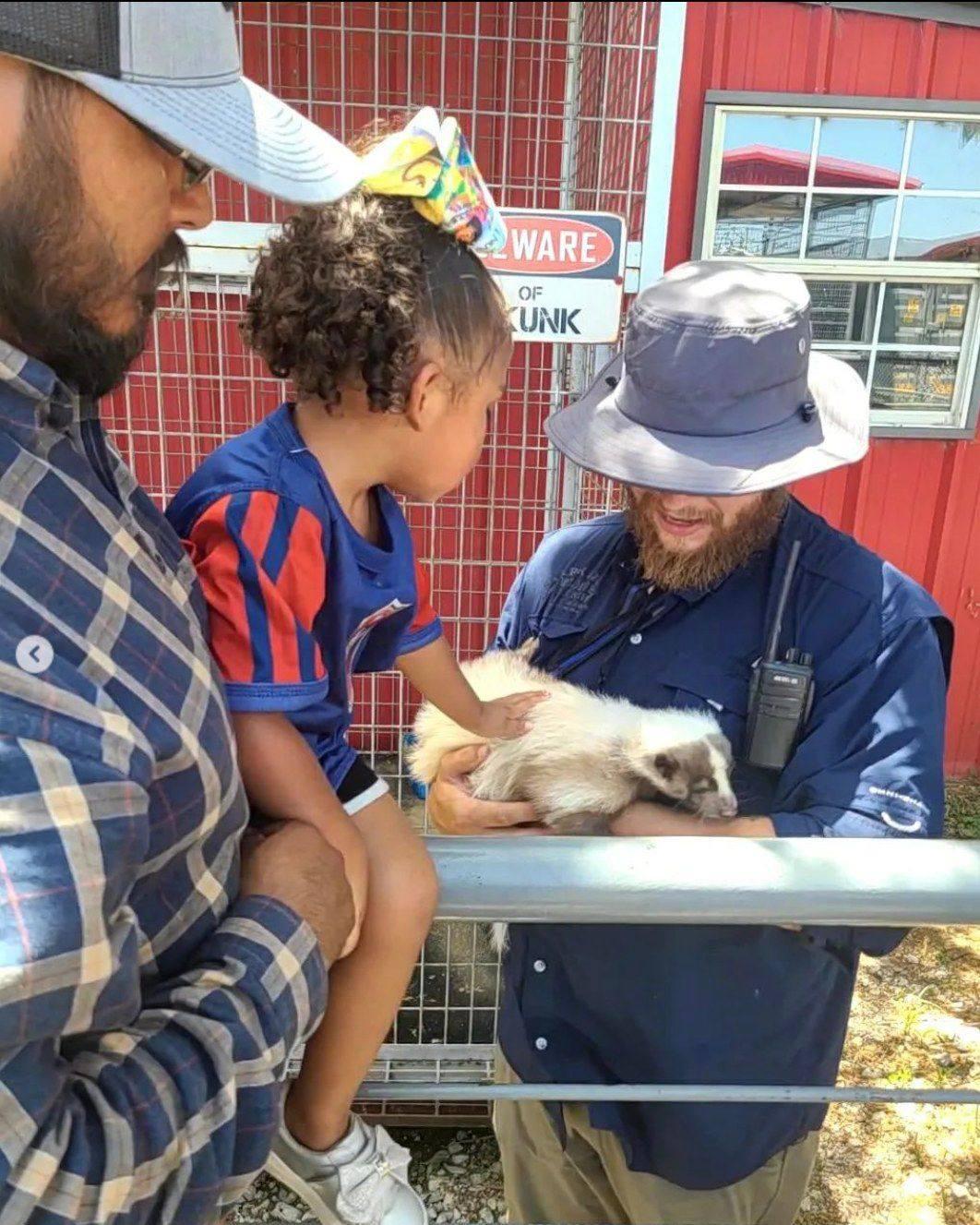 Skunk and handler with family.