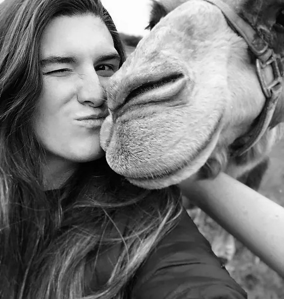 Intern at Sharkarosa Zoo kissing a camel