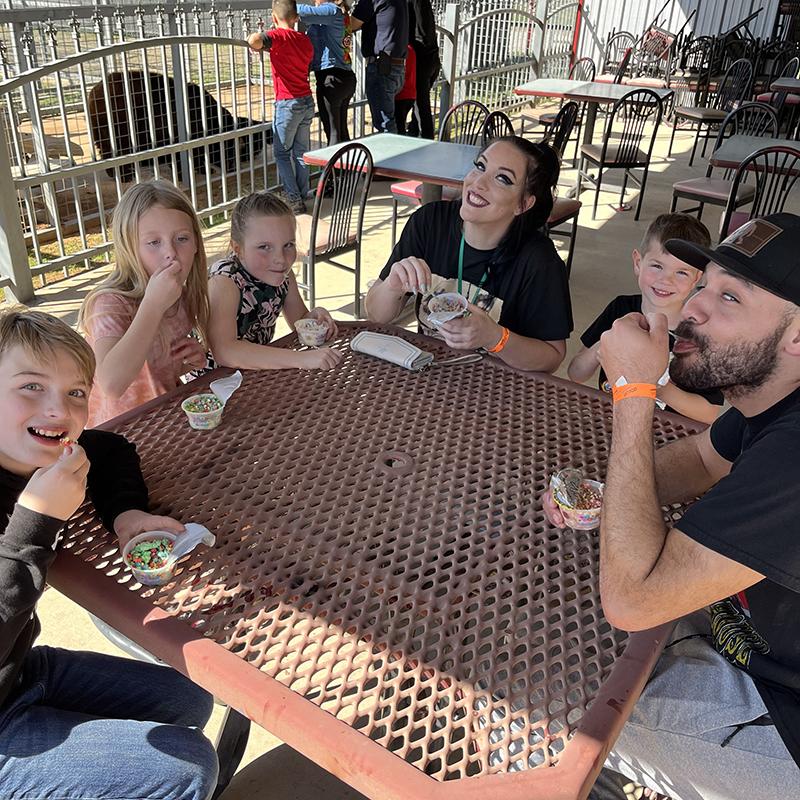 Family eating ice cream at table at Sharkarosa Zoo