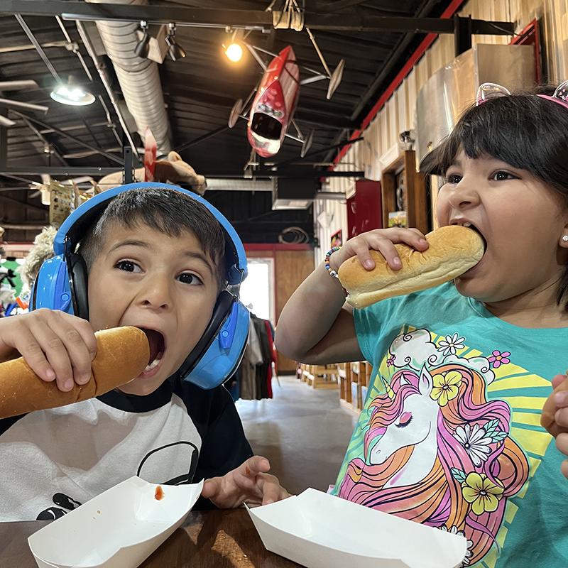 Kids eating hot dogs at Sharkarosa